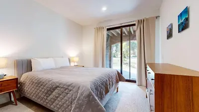 a bedroom with a bed and a large window at Cozy Cabin for 8 Close to Eagle Lodge in Mammoth Lakes