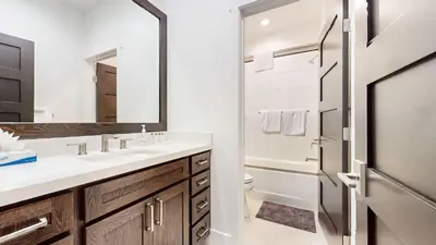 a bathroom with a sink and a toilet and a mirror at Cozy Cabin for 8 Close to Eagle Lodge in Mammoth Lakes