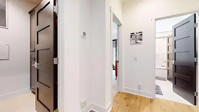 a hallway with a black door and a mirror at Cozy Cabin for 8 Close to Eagle Lodge in Mammoth Lakes