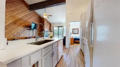 a kitchen with a sink and a refrigerator at Crestview #2 Close to The Village Near Year-Round Outdoor Activities in Mammoth Lakes