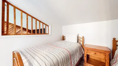 a small bedroom with a bed and a wooden table at Crestview #2 Close to The Village Near Year-Round Outdoor Activities in Mammoth Lakes