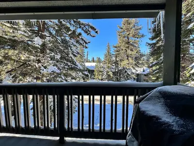 a balcony with a view of snow covered trees at Chic 1 BDR Loft with Hot Tub Near Canyon Lodge in Mammoth Lakes