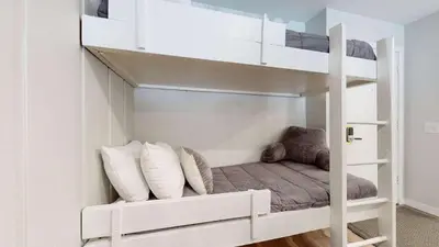 a white bunk bed in a room with pillows at Emerson Escape Incredible Moments at Mammoth in Mammoth Lakes