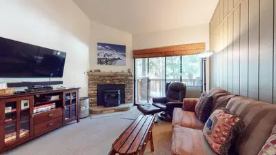 a living room with a couch and a television at Escape to The Summit Pool & HT Next Door in Mammoth Lakes