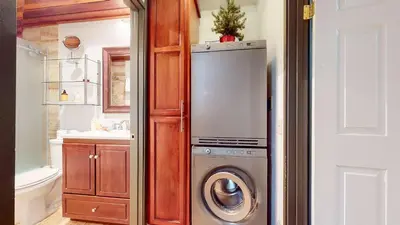 a kitchen with a refrigerator and a washing machine at Escape to The Summit Pool & HT Next Door in Mammoth Lakes