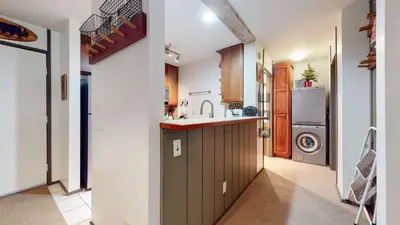 a kitchen with a sink and a washing machine at Escape to The Summit Pool & HT Next Door in Mammoth Lakes