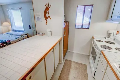 a kitchen with a counter and a bed in a room at Studio with Amenities Walk to Village in Mammoth Lakes