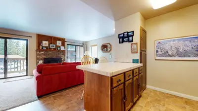 a kitchen and living room with a red couch at Hidden Valley Homestead Near Hike Bike & More in Mammoth Lakes