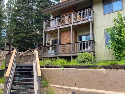a house with a staircase in front of a building at Hidden Valley Homestead Near Hike Bike & More in Mammoth Lakes