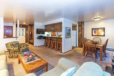 a living room with a couch and a table at Horizons Year-Round Fun with Rec Room in Mammoth Lakes