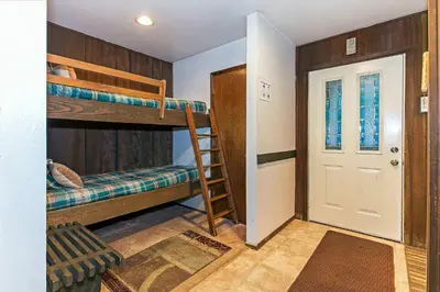 a room with two bunk beds and a door at Horizons Year-Round Fun with Rec Room in Mammoth Lakes