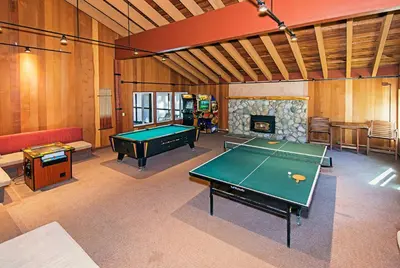 a room with a pool table and a fireplace at Horizons Communal Sauna & Hot Tub in Mammoth Lakes