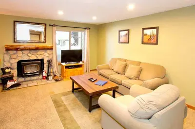 a living room with a couch and a fireplace at Horizons Condo with Communal Clubhouse in Mammoth Lakes