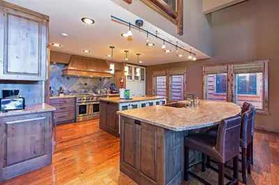 a large kitchen with a large island in the middle at Stonegate #02 Luxe Condo with Foosball Table in Mammoth Lakes