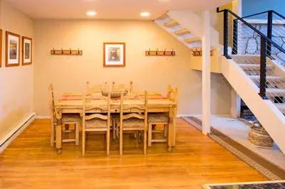 a dining room with a table and a staircase at Summit #20 Near DT Hike Bike & Ski in Mammoth Lakes