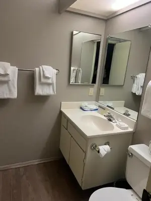 a bathroom with a sink and a toilet and a mirror at Sunshine Village #142 Close to Shops & Eats in Mammoth Lakes