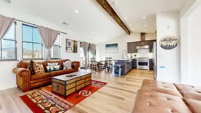 a living room with a couch and a table at An Adventure of a Lifetime 3 BDR 5 Min to Skiing in Mammoth Lakes