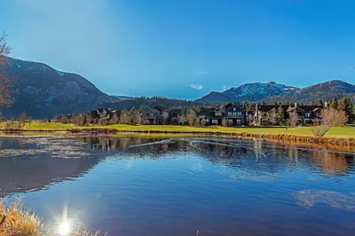a body of water with houses and mountains in the background at An Adventure of a Lifetime 3 BDR 5 Min to Skiing in Mammoth Lakes