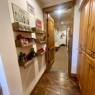 a room with a hallway with a door and shelves at The Lodges by 8th Hole Year-Round Fun in Mammoth Lakes