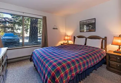 a bedroom with a bed and a large window at Viewpoint #131 Walk to Eats & Entertainment in Mammoth Lakes