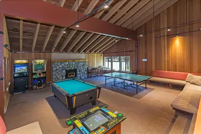 a living room with two ping pong tables and a fireplace at Horizons 4 - Excellent for Groups in Mammoth Lakes