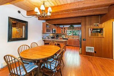 a dining room with a wooden table and chairs at Winterset #02 Shared Hot Tub & Pool in Mammoth Lakes