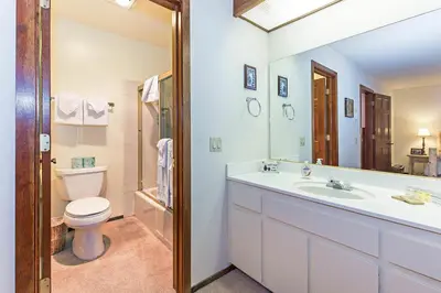 a white bathroom with a sink and a toilet at Winterset #18 Shared Pool & Near Skiing in Mammoth Lakes