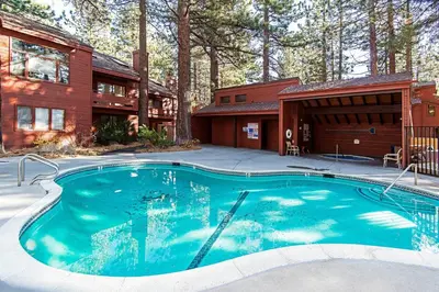 a swimming pool in front of a house at Winterset #28 Shared Hot Tub & Sauna in Mammoth Lakes