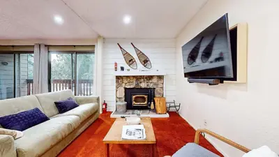 a living room with a couch and a fireplace at Cozy Condo for 4 Near Shuttle & Eagle Lodge in Mammoth Lakes