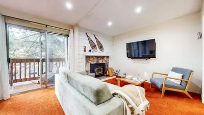 a living room with a couch and a fireplace at Cozy Condo for 4 Near Shuttle & Eagle Lodge in Mammoth Lakes