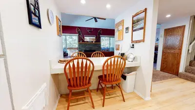 a kitchen with a counter and two chairs at a table at La Residence - Shared Pool Hot Tub & More in Mammoth Lakes