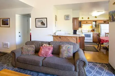 a living room with a couch and a kitchen at La Vista Blanc #22 - Near Shuttle BBQ & Pool in Mammoth Lakes