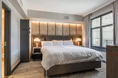 a bedroom with a large bed and a large window at 2 BDR Family Resort Condo with Pool Lounge & Mountain Views in Mammoth Lakes