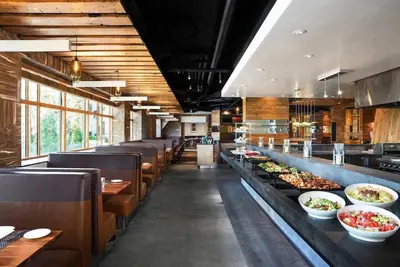 a restaurant with a buffet line with plates of food at 2 BDR Family Resort Condo with Pool Lounge & Mountain Views in Mammoth Lakes