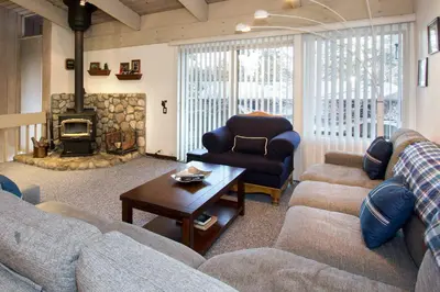 a living room with a couch and a chair and a fireplace at Mammoth Estates - 4 Seasons of Beauty with Accessible Amenities in Mammoth Lakes
