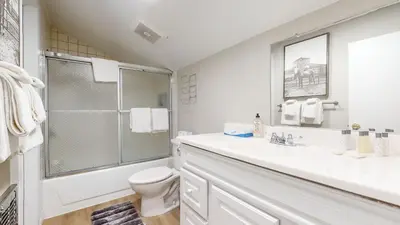 a white bathroom with a shower and a toilet at Mammoth Getaway - Chic Condo in Mammoth Lakes