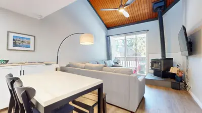 a living room with a couch and a table at Mammoth Getaway - Chic Condo in Mammoth Lakes