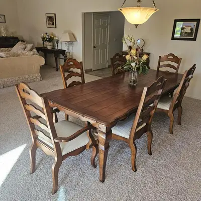 a wooden dining room table with chairs and a couch at Waterfront Elegance in Discovery Bay