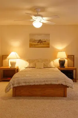 a bedroom with a bed with a ceiling fan at Waterfront Elegance in Discovery Bay