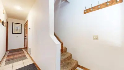 a staircase in a home with white walls at Mammoth Hygge - Centrally Located in Mammoth Lakes