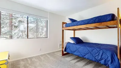 a bedroom with a bunk bed and a window at Cozy Cabin for 6 - Near Canyon Lodge & Slopes in Mammoth Lakes