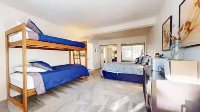 a bedroom with two bunk beds and a television at Cozy Cabin for 6 - Near Canyon Lodge & Slopes in Mammoth Lakes