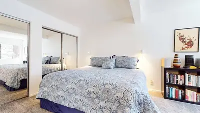 a bedroom with a bed and a large mirror at Cozy Cabin for 6 - Near Canyon Lodge & Slopes in Mammoth Lakes