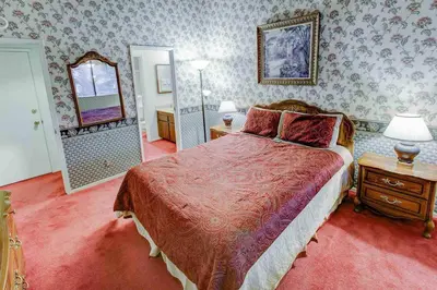 a bedroom with a large bed and a mirror at Mammoth Ski & Racquet with Shared Hot Tub & Pool in Mammoth Lakes