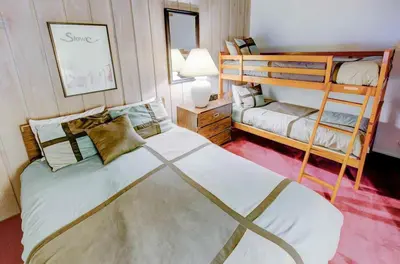 a bedroom with a bed and a bunk bed at Mammoth Ski & Racquet with Shared Hot Tub & Pool in Mammoth Lakes