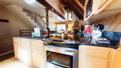 a kitchen with a stove and a counter top at Mammoth View Villas - Near Hike & Bike Trails in Mammoth Lakes