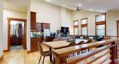 a kitchen and living room with a table and chairs at Red Slate Canyon - Modern 2-Story Condo in Mammoth Lakes