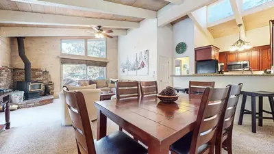 a kitchen and dining room with a wooden table and chairs at Mountain Chateau Retreat - Desirable Resort 4 BDR in Mammoth Lakes