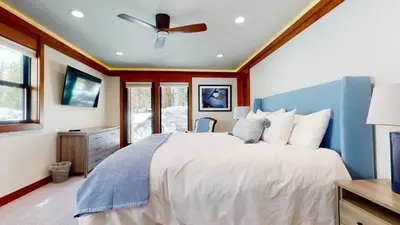 a bedroom with a bed and a ceiling fan at Obsidian Dreaming - On the Sierra Star Golf Course in Mammoth Lakes