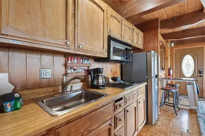 a kitchen with a sink and a refrigerator at Stunning Views at Stargazer - Lakefront Studio in Crystal Bay